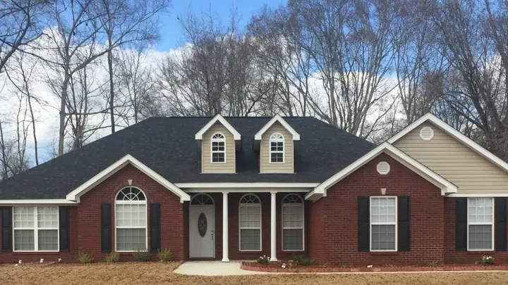 The Calloway plan: red brick home with two dormers and a side-gable wing