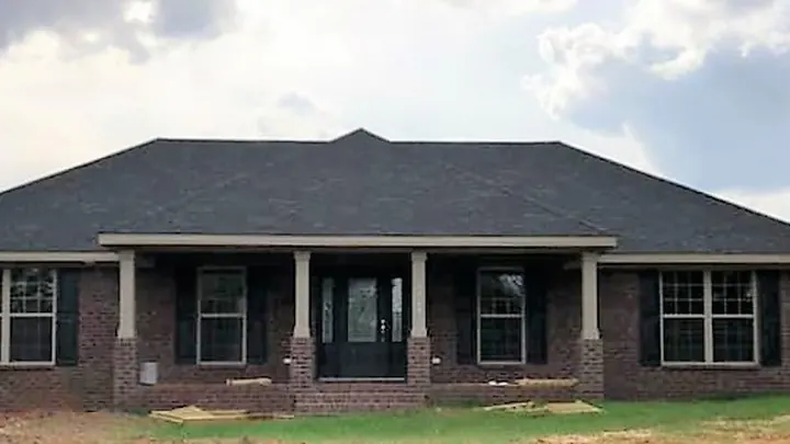 The Deerfield plan: dark brick home with a full-width columned porch