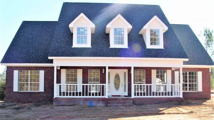 The Fairview plan: brick home with three dormers and a wide columned porch
