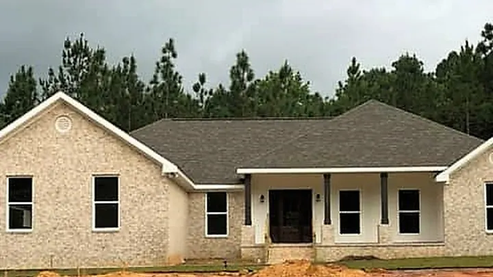 The Riverwood plan: light brick home with a recessed columned entry
